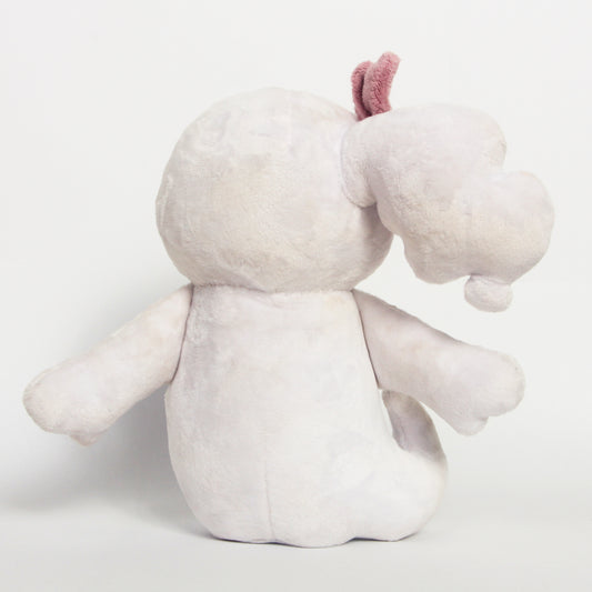 The back of a plush toy photographed against a plain light gray studio background.